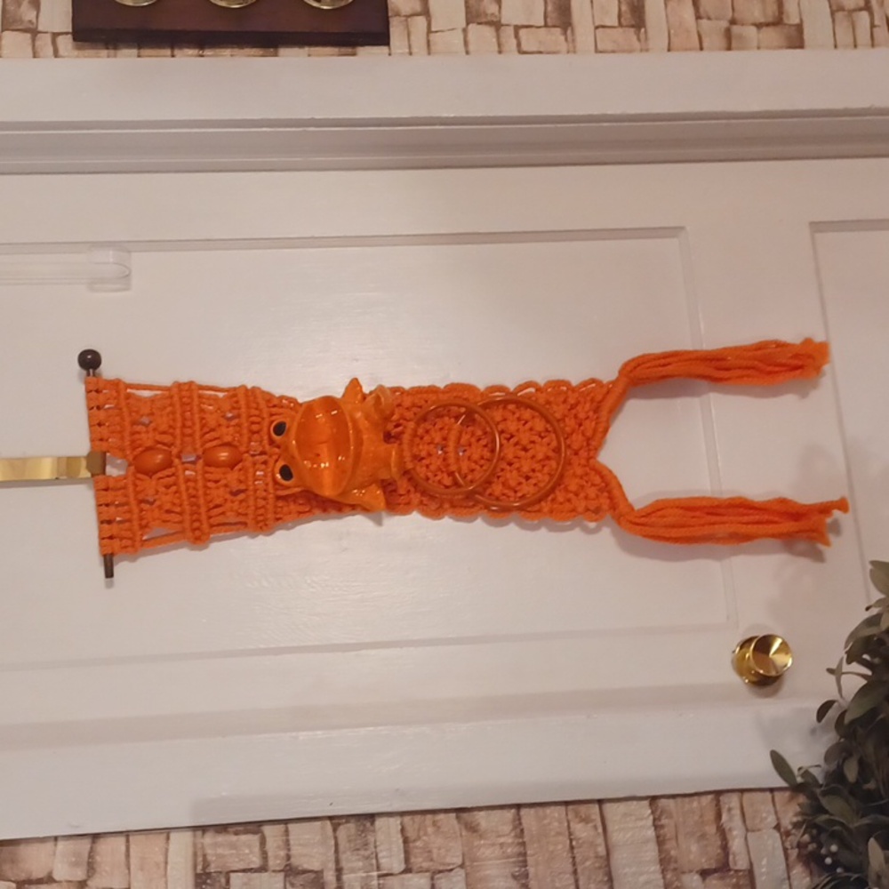 Vintage macrame towel holder with a ceramic frog orange bathroom decor